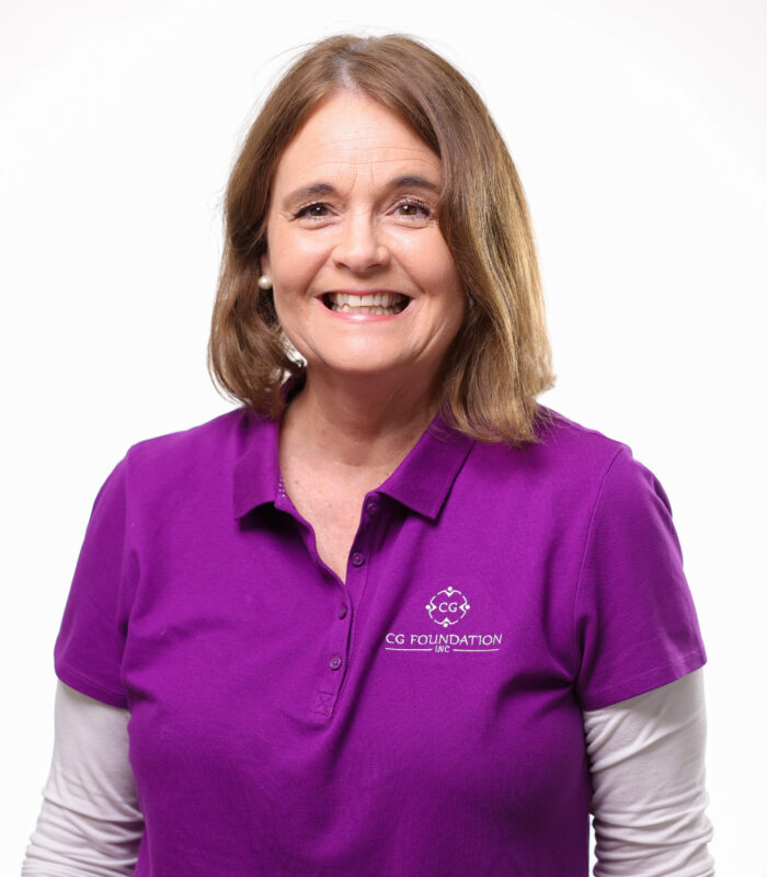 Meet Our Team - Professional and Welcoming Group at a Conference Table Faces the Camera, Team Leader Sitting on the Table with Arms Folded